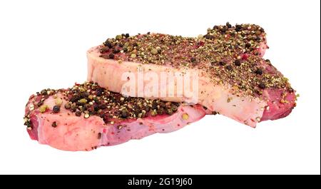 Two peppercorn covered raw sirloin steaks isolated on a white background Stock Photo