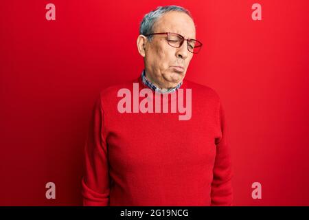 Handsome senior man with grey hair wearing casual clothes and glasses depressed and worry for distress, crying angry and afraid. sad expression. Stock Photo