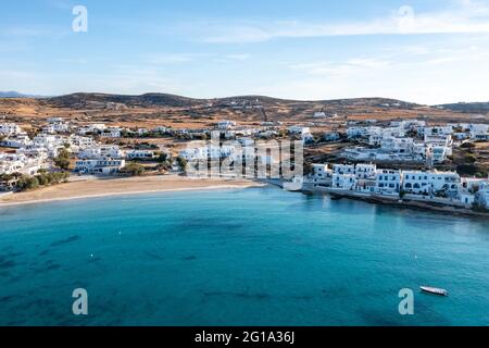 Greece, Koufonisi island, small Cyclades. Aerial drone view. Pano Koufonisi white traditional village buildings, Megali Ammos sandy beach. Calm turqui Stock Photo