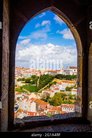 LISBON, PORTUGAL - MARCH 25, 2017: A view of Lisbon orange roofs through the old window of Sao Jorge Castle, Portugal Stock Photo