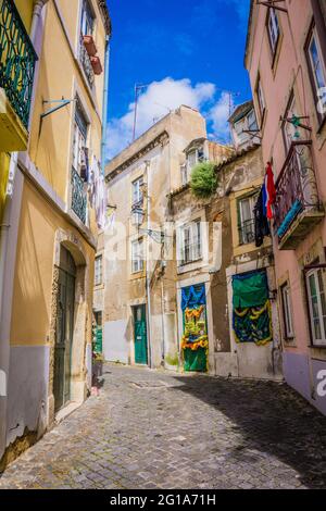 LISBON, PORTUGAL - MARCH 25, 2017: Narrow old streets with vintage balconies of Alfama district, Lisbon, Portugal Stock Photo