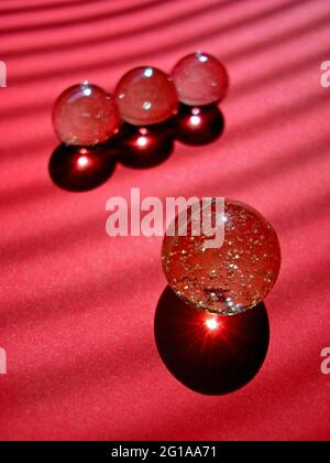 Marbles balls on red background Stock Photo