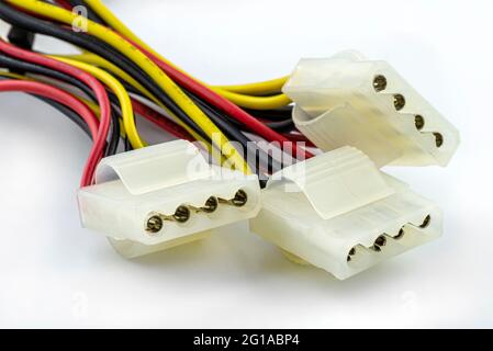 A four-pin female plug for powering a hard disk or CD drive coming from a computer power supply, isolated on a white background. Stock Photo