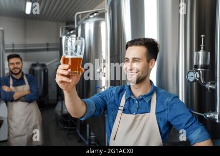 Family small business. Professional brewer on own craft alcohol production Stock Photo