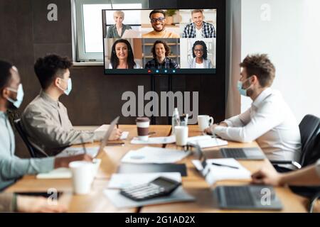 Diverse businesspeople making online videocall to employees Stock Photo