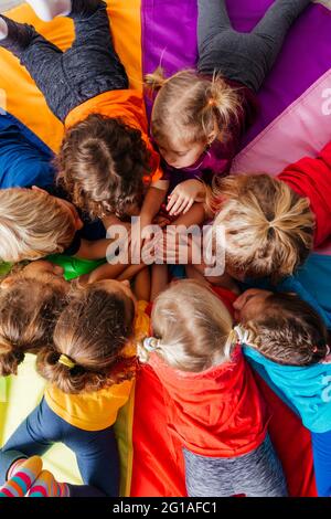 Cheerful children playing team building games on a floor Stock Photo