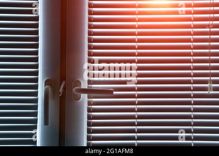 Office blinds. Modern jalousie on the windows in the room. Sunlight Stock Photo