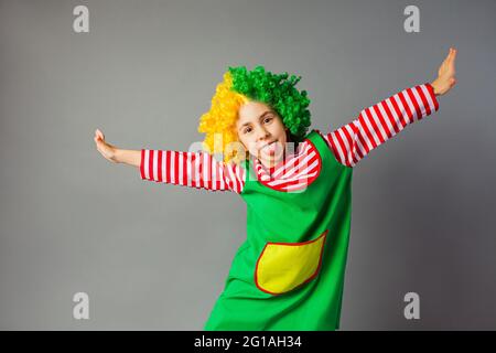 The funny little girl in a clown uniform Stock Photo