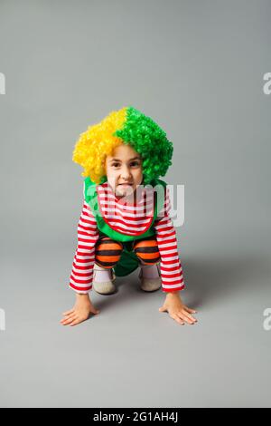 The little girl jumps in a clown uniform Stock Photo