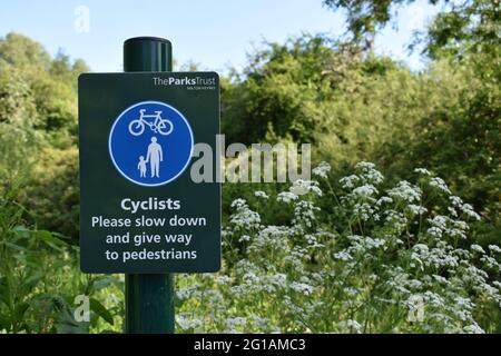 Notice for cyclists: 'Give way to pedestrians' with copyspace. Stock Photo