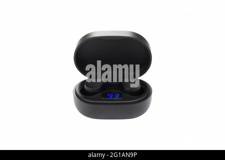 Modern black wireless earbuds headphones lying in charge case isolated on white background. Stock Photo