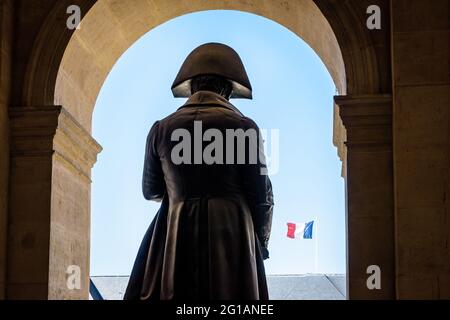 Close-up view of the back of the statue of Napoleon Bonaparte in the Hotel des Invalides in Paris, with a french flag flying in the distance. Stock Photo