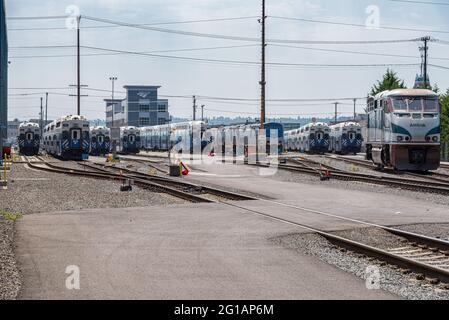 Sound Transit commuter trains and and Amtrak passenger train at the ready at South Seattle, WA Stock Photo