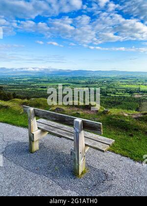 An empty bench near the edge of the road at Vee Pass, a v-shaped turn on the road leading to a gap in the Knockmealdown mountains in Clogheen county T Stock Photo