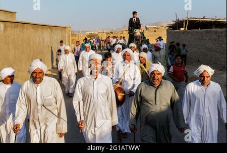 Groom riding a camel during his traditional wedding ceremony in north of Qeshm Island. Stock Photo