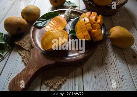 Sliced mango on wooden board with use of selective focus Stock Photo