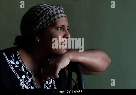 Ana Maria’s home is full of love and food. She has understood her life in this way after.her mother threw her out of her house at the age 14 and after her belly squeaked of hunger during the so-called “special period”. Her house is filled with women. She is divorced and raises two teenage daughters. She yearns for the time when everyone was an equal in Cuba. 'Nowadays, you worth the money you have. That makes me suffer in silence.' She considers herself a revolutionary woman and chooses Cuba as the country where she expects to spend her life and death. She learnt how to fly by writing short st Stock Photo