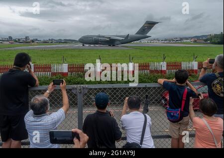 People takes photos of the U.S. Air Force C-17 Globemaster III transport aircraft that landed at Taipei Shongshan Airport.The United States will donate 750,000 COVID-19 vaccine doses to Taiwan as part of the country's plan to share millions of jabs globally. Three US Senators Tammy Duckworth, Dan Sulivan and Chris Coons, visited Taiwan on Sunday (June 6th), by taking the U.S. Air Force C-17 Globemaster III freighter, rather than a private jet as is generally the case for senior U.S. visitors, which showed the US's commitment to Taiwan as it faces its biggest outbreak since the pandemic began a Stock Photo