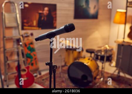 Microphone among musical instruments in sound recording studio Stock Photo