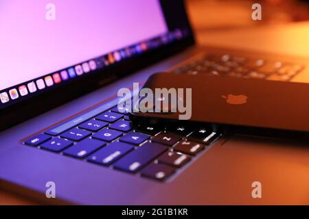 Tokyo, Japan. 06th June, 2021. In this photo illustration, Apple's iPhone 12 seen placed on a MacBook Pro. Credit: SOPA Images Limited/Alamy Live News Stock Photo