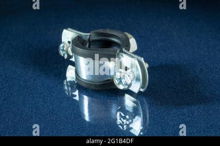 Steel water pipe clamp on the table with reflection. Locksmith tools for repair Stock Photo