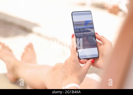 Woman is editing taken photo on smartphone Stock Photo