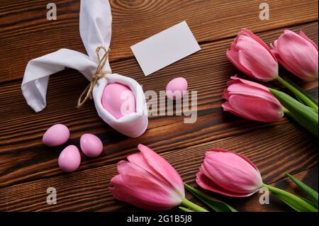 Pink tulips and easter egg on wooden background Stock Photo