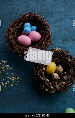 Easter eggs in decorative nests and greeting card Stock Photo