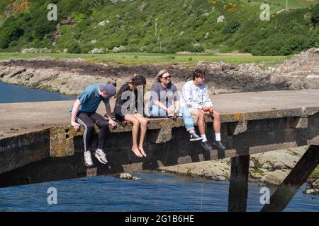 Portencross, Scotland, UK. 6th June 2021. UK Weather: Sitting on Portencross Pier fishing with lines and nets. Credit: Skully/Alamy Live News Stock Photo