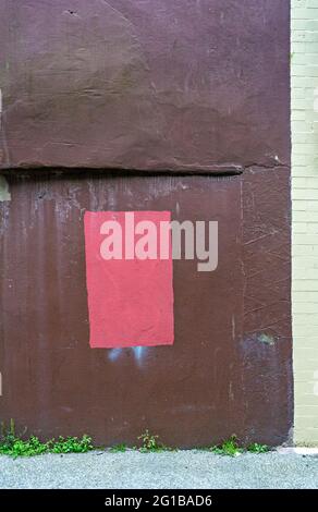 Red-painted rectangle on brown-painted wall Stock Photo