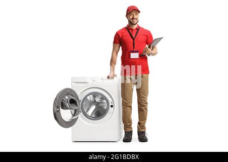 Full length portrait of a shop assistant leaning on an open washing machine isolated on white background Stock Photo