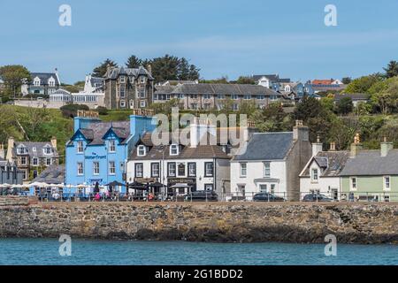 The image is of seafront houses that line the promenade at Portpatrick a small coastal town and past ferry port on the Dumfries and Galloway peninsula Stock Photo