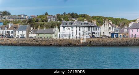 The image is of seafront houses that line the promenade at Portpatrick a small coastal town and past ferry port on the Dumfries and Galloway peninsula Stock Photo