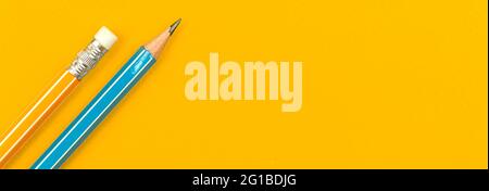 School lead pencil on the yellow desktop, education banner concept with copy space, top view Stock Photo