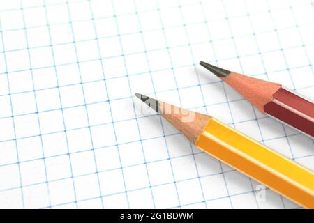 Lead pencils on a checkered notebook page background, education concept, copy space Stock Photo