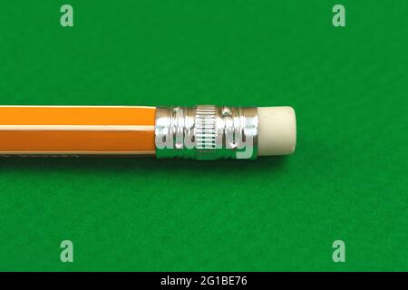 Close-up of school yellow pencil eraser, green table office desktop background, copy space Stock Photo