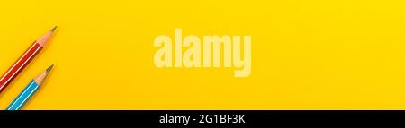 Banner with simple school supplies, school pencils on a yellow desktop background, with copy space, top view Stock Photo