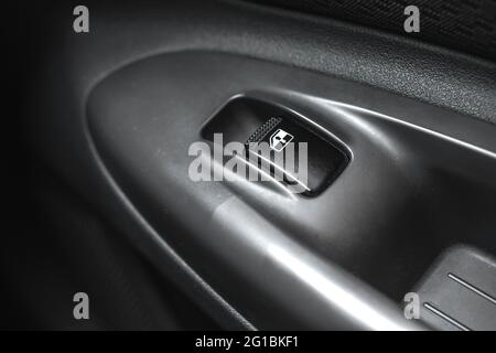 Black car window lifter button in car door close up background Stock Photo