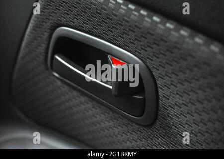 Car door handle inside, close up photo, interior of modern car with luxury upholstery Stock Photo
