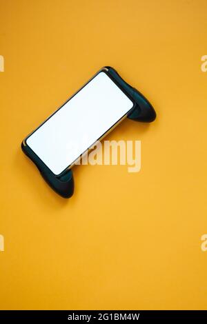 Joystick mobile phone, screen mockup Isolated on yellow background top view Stock Photo