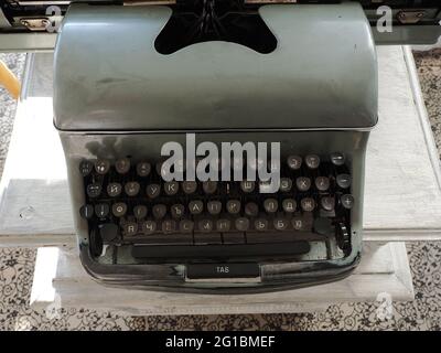 An old gray typewriter with white Cyrillic letters on black keys and one missing key. Stock Photo