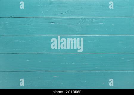 Texture of wooden planks surface of turquoise color. Background of green blue horizontal wood boards. Pattern of slightly scratched rustic table top. Stock Photo