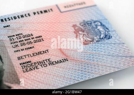 New type of biometric residence permit BRP card issued by Home Office in the UK in July 2021.  Close up of Residence Permit document for Indefinite Le Stock Photo