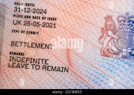 New type of biometric residence permit BRP card issued by Home Office in the UK in July 2021.  Close up of Residence Permit document for Indefinite Le Stock Photo