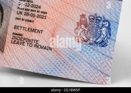 New type of biometric residence permit BRP card issued by Home Office in the UK in July 2021.  Close up of Residence Permit document for Indefinite Le Stock Photo