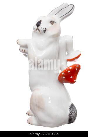 Porcelain figurine of a hare carrying amanita mushrooms, isolated on white background Stock Photo