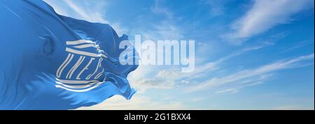 Minsk, Belarus - May, 2021: Flag of UNESCO World Heritage Committee waving in the wind at flagpole on background of blue sky. 3d illustration. Stock Photo