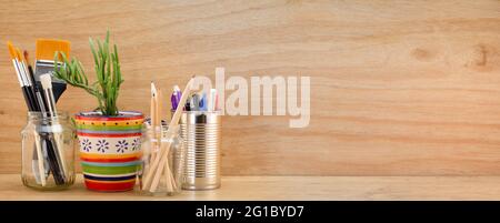 Recycled reused jars, tin and mug reused for different contents on wooden bench,  copy space Stock Photo