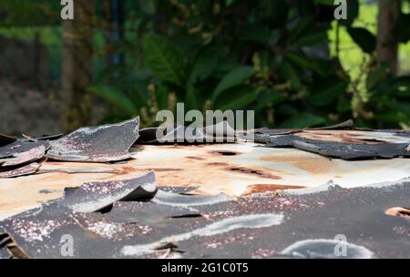 Close-up of peeled body paint from top of an old car. Selective focus points. Blurred background Stock Photo