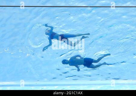 London, UK. Swimmers enjoy a dip in the newly opened transparent Sky Pool which is suspended between two buildings 115ft up in the air. Stock Photo